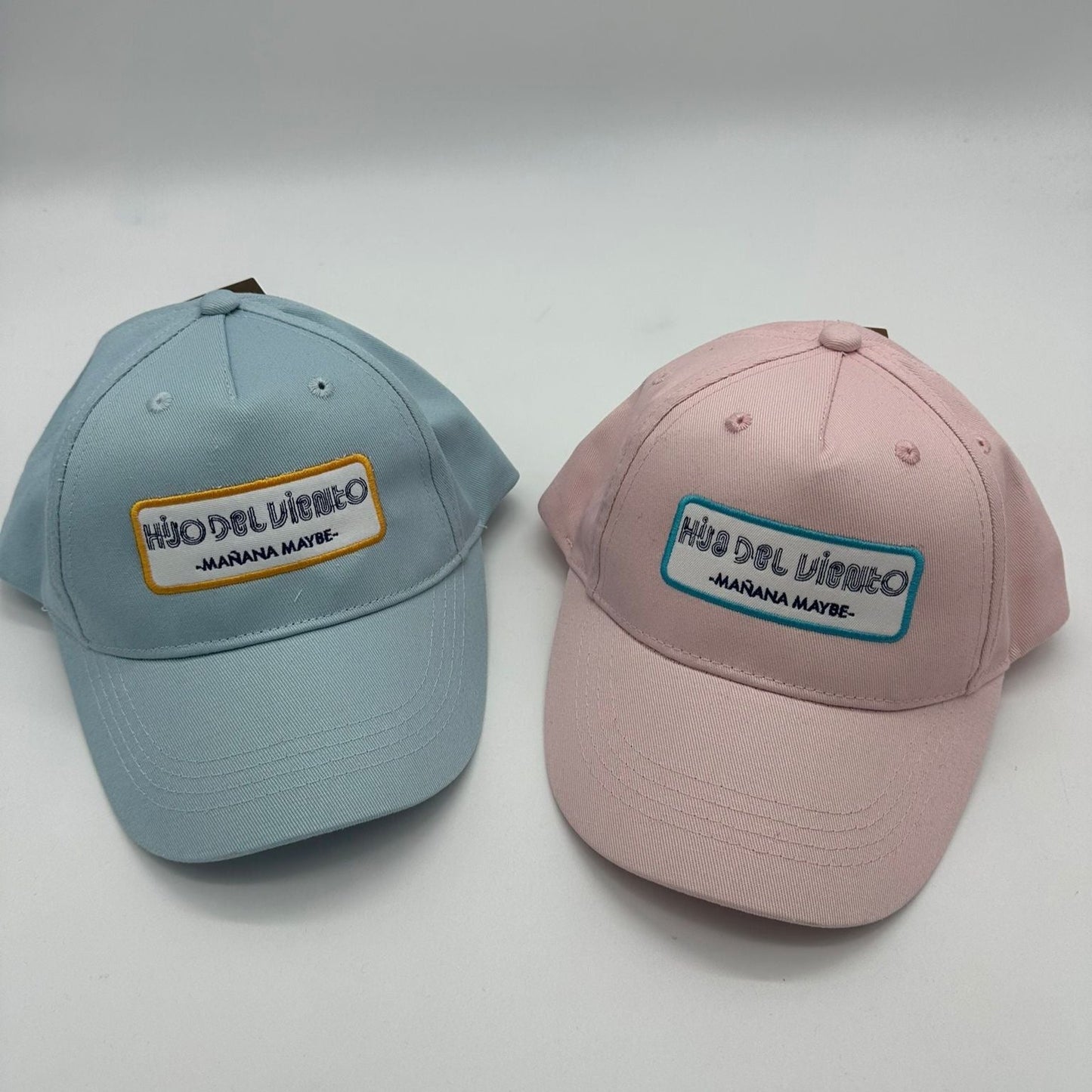 Blue and pink organic caps embroidered