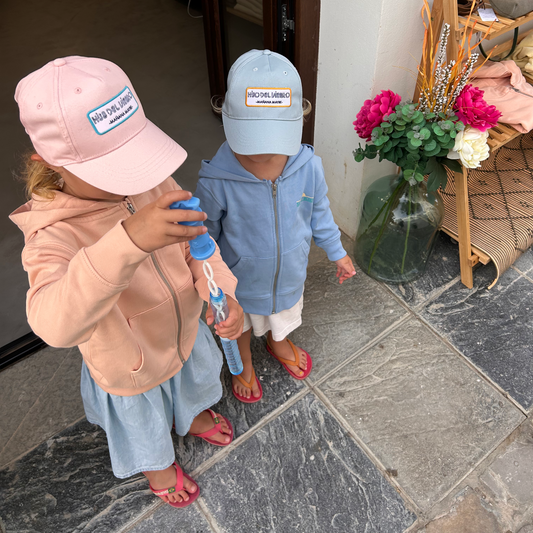 Kids wearing caps in front of shop